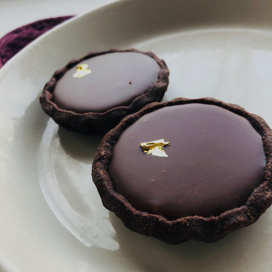 Load image into Gallery viewer, 1 Dozen 2-inch Dark Chocolate Tarts with Earl Grey Caramel
